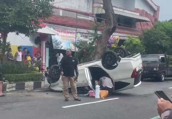 Toyota Calya terbalik setelah melintasi marka dan menabrak pohon di jalanan Magetan, Sabtu (2/3/2024). Foto: Neumedia.id/Fatihah